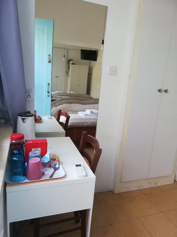 Bedroom corner with white table and chair