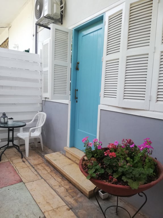 Blue door and white window in a small garden